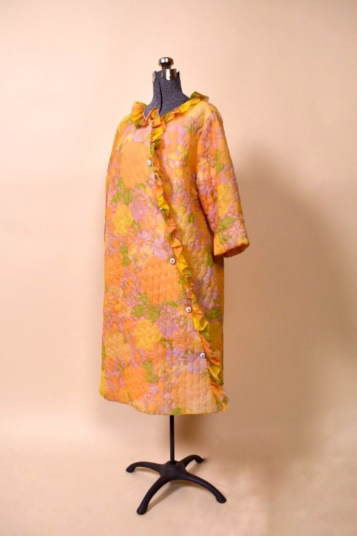 50s/60s Orange, Pink, and Yellow floral long bed jacket from the side 