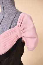 Load image into Gallery viewer, Sleeve of the black and pink dress is shown up close. The sleeve is pleated.
