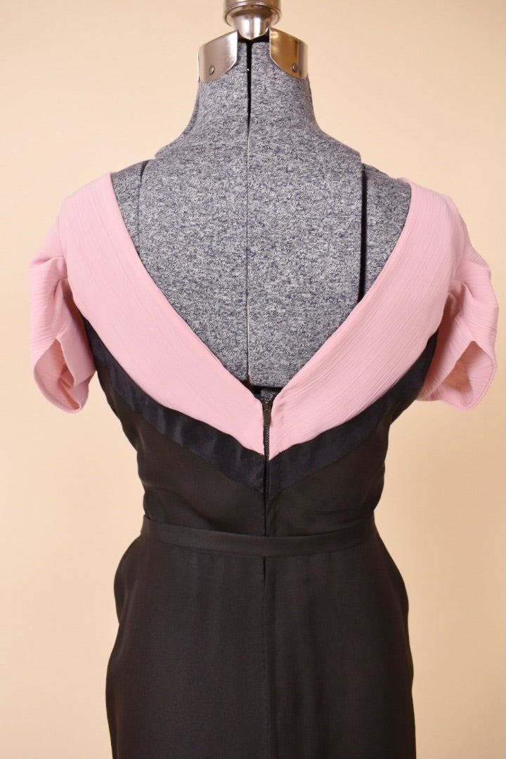 Back of the black and pink dress is shown up close. The back features a v-neckline.