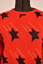 Load image into Gallery viewer, close up of black star with gold motion lines on red knit sweater
