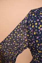 Load image into Gallery viewer, Designer Zadig and Voltaire short navy dress with star patterns is shown in close up. This dress has sheer sleeves.
