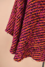 Load image into Gallery viewer, Vintage pink and orange knit cape is shown in close up. This wool cape has a fuzzy boucle knit.
