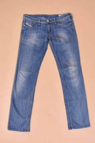 Vintage Y2K super low rise light wash jeans by Diesel are shown from the front. These jeans have silver tone stitching. 