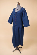 Load image into Gallery viewer, Vintage 80s dark wash navy maxi length dress is shown from the side. This dress has a scoop neckline. 
