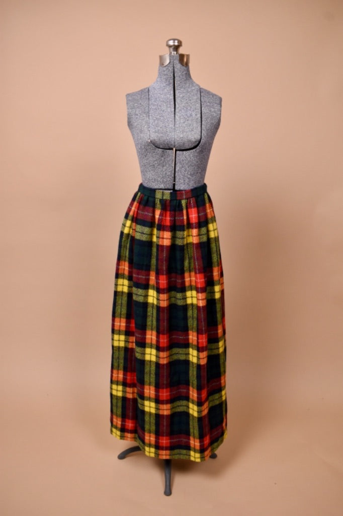 The skirt rests at the mannequin natural waist and is nearly floor length.