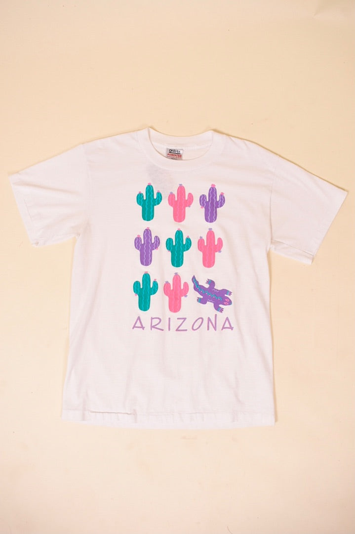 Vintage 1980's pink, purple, and green cactus and lizard graphic Arizona tee shirt is shown from the front. 
