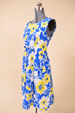 Load image into Gallery viewer, Vintage 60s blue and yellow flower print midi dress is shown from the side. 
