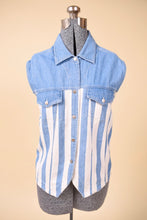Load image into Gallery viewer, Vintage white and blue vertical stripe sleeveless denim top is shown from the front. This 90s sleeveless button down has two pockets at the bust. 
