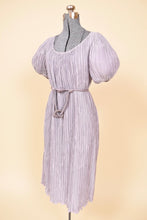 Load image into Gallery viewer, Vintage 80s lavender purple Pierre Labiche pleated babydoll dress is shown from the side. This pastel purple dress has short puff sleeves. 
