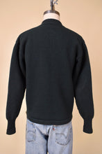 Load image into Gallery viewer, Antique 1940&#39;s dark green University of Vermont letterman sweater by Lanza is shown from the back. This vintage Vermont sweater has ribbed cuffs. 
