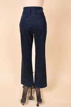 Load image into Gallery viewer, Vintage Y2K navy denim jeans are shown from the back. These designer St John jeans have a high waisted fit. 
