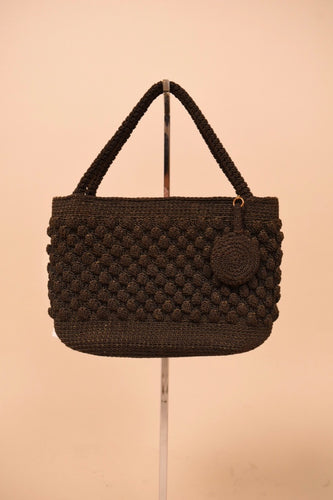 Vintage black woven textured handbag is shown from the front.