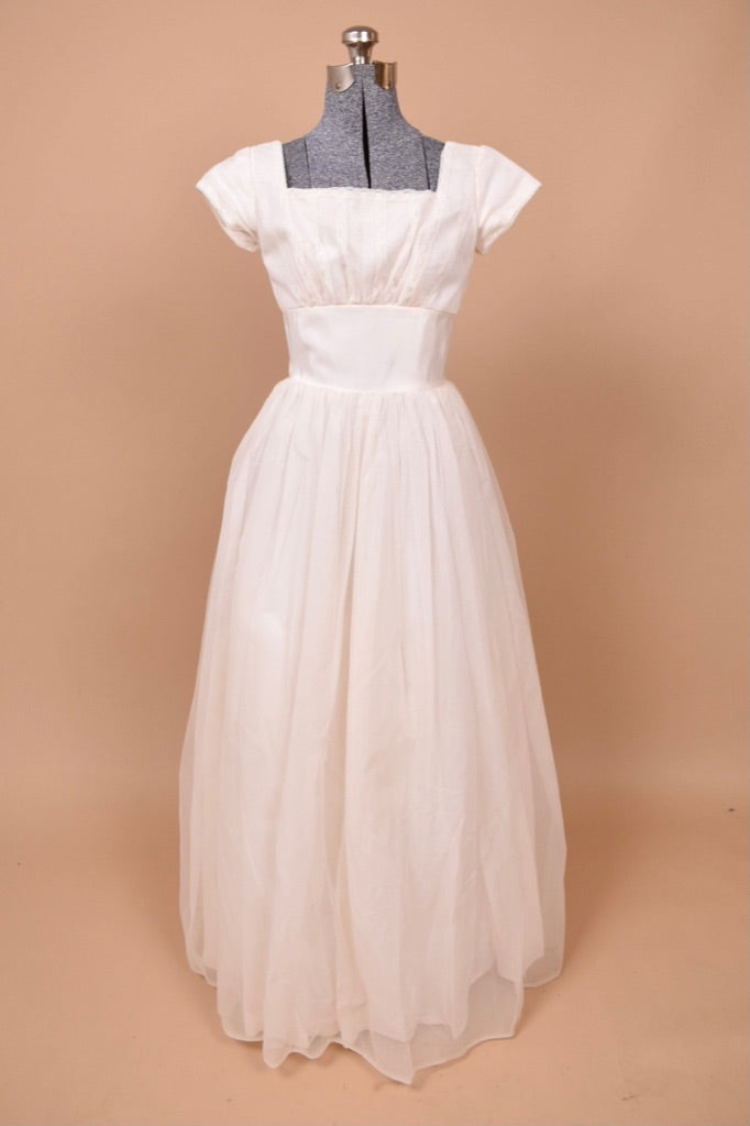 Vintage 1950s princess style wedding dress by Harry Keiser is shown from the front. This dress has a square neckline and cap sleeves.