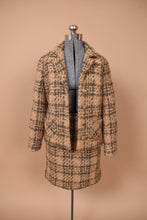 Load image into Gallery viewer, Vintage sixties Peck &amp; Peck skirt and blazer set is shown from the front. This blazer is made from a tan tweed with two front pockets. 
