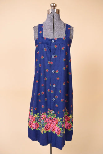 Vintage 60's royal blue floral pattern tent sundress is shown from the front. This dress has buttons down the front. 