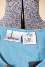 Load image into Gallery viewer, Vintage nineties pastel blue linen and cotton blend XL tank top is shown in close up. This top has a tag that reads Willi Wear. 
