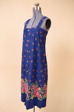 Load image into Gallery viewer, Vintage royal blue 60s french sundress is shown from the front. This summery midi dress has a bright pink floral pattern.
