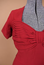 Load image into Gallery viewer, Vintage 1940&#39;s antique deep red crepe gown is shown in close up. This dress has cap sleeves made of a pleated slinky material.
