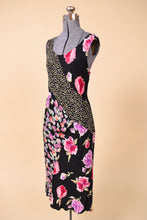 Load image into Gallery viewer, Vintage 90s patchwork printed pink and black rayon dress is shown from the side. This slinky sleeveless dress has different floral and dot patterns. 
