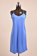Load image into Gallery viewer, Vintage seventies blue polyester slip dress is shown in close up. This blue slip has spaghetti straps. 
