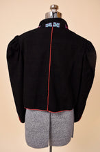Load image into Gallery viewer, Vintage eighties black and red cropped bolero jacket is shown from the back. This jacket has puff shoulders. 
