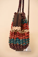 Load image into Gallery viewer, Vintage woven seagrass handmade handbag is shown from the side. This natural woven purse has a zipper. 
