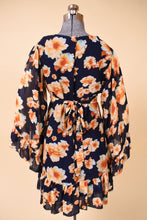 Load image into Gallery viewer, Vintage Betsey Johnson ruffle mini dress is shown from the back. This navy blue boho mini has yellow and orange floral print.
