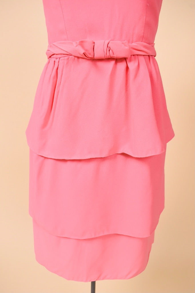 Vintage bubblegum pink mini dress by Ann Barry is shown in close up. 