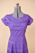 Load image into Gallery viewer, Vintage bright purple tea dress is shown from the front. This dress has a wide boatneck.
