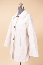 Load image into Gallery viewer, Vintage 60&#39;s white leather swing jacket by Sills Bonnie Cashin is shown from the side. This leather jacket has two front pockets.
