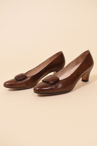 Vintage brown leather short heels by Salvatore Ferragamo are shown from the side. These leather pumps have a tortoise buckle on the toe. 