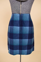 Load image into Gallery viewer, Vintage two piece blue plaid wool skirt set is shown in close up. This wool 70&#39;s skirt has a zipper at the back. 
