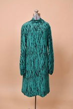 Load image into Gallery viewer, The dress faces forward on a mannequin. It has a mock neck and long sleeves.
