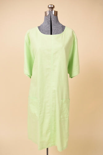 Vintage 2000's electric green linen shift dress is shown from the front. This dress has two front pockets. 