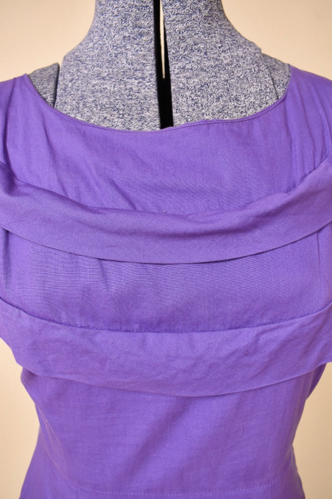 Vintage purple 50's cotton midi dress by Brief Measure is shown in close up. This dress has ruffled details on the neckline. 