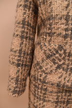 Load image into Gallery viewer, 1960s vintage tan tweed skirt and blazer set is shown in close up. This classic set is made from a tan and brown tweed. 
