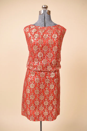 Vintage 1960's red metallic lace party dress by Algo is shown from the front. This dress has a gold lace overlay. 