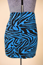 Load image into Gallery viewer, Vintage Y2K party stretchy animal print mini skirt is shown from the front. 
