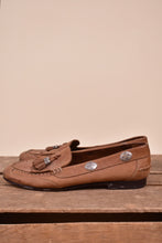 Load image into Gallery viewer, Vintage brown suede loafers by Jones New York are shown from the side. These loafers have silver concho details on the side. 
