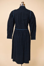 Load image into Gallery viewer, Vintage seventies calico print midi prairie dress is shown from the back. This blue floral dress has long puff sleeves. 
