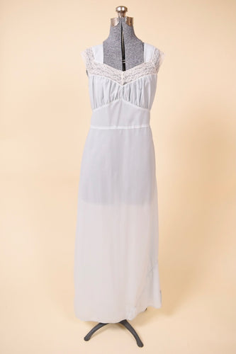 Vintage 1960s pale blue semi sheer slip dress by Radcliffe is shown from the front. This dress has white lace trim. 