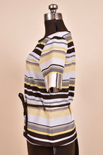 Load image into Gallery viewer, Vintage striped shirt is shown from the side. The shirt has yellow and brown stripes.
