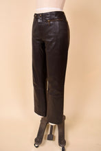 Load image into Gallery viewer, Vintage brown leather Y2K pants are shown from the side. These pants have moto inspired hardware at the waist. 
