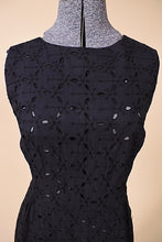 Load image into Gallery viewer, Vintage 1950&#39;s eyelet black cotton midi sleeveless shift dress is shown in close up. 
