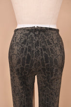 Load image into Gallery viewer, Vintage nineties flared cropped snakeskin print pants are shown in close up. These pants have a zipper at the back.
