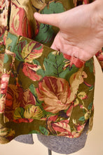 Load image into Gallery viewer, Made in New Hampshire olive green chore coat is shown in close up. This jacket has two front pockets. 

