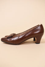 Load image into Gallery viewer, Vintage brown leather Salvatore Ferragamo pumps are shown from the side. These vintage heels have a low chunky heel. 
