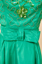 Load image into Gallery viewer, Vintage 60&#39;s emerald green acetate mini party dress is shown in close up. This dress has a bow detail at the waist. 
