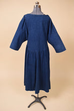 Load image into Gallery viewer, Vintage eighties ILGWU union made denim dress is shown from the back. This dark navy denim dress has batwing sleeves. 
