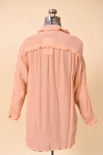 Load image into Gallery viewer, Vintage lacy peach pink frilly button down silk crepe top is shown from the back. This button down top is made from a textured silk crepe. 

